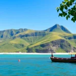 Scenic sunset over Lombok with lush hills, clear blue waters, and traditional fishing boats, capturing island's natural beauty.