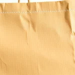 Eco-friendly torba papierowa being held by a person on a white background, emphasizing