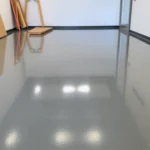 Experienced epoxy resin flooring contractors Birmingham applying durable epoxy coating in