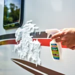 Effective Wohnmobilreiniger in action cleaning a shiny motorhome on a sunny day, highlighting